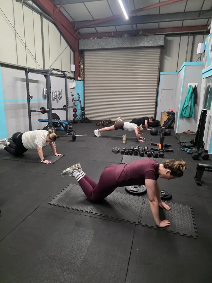 A client holding a plank on the mats in the Let Luce studio at Unit 49.