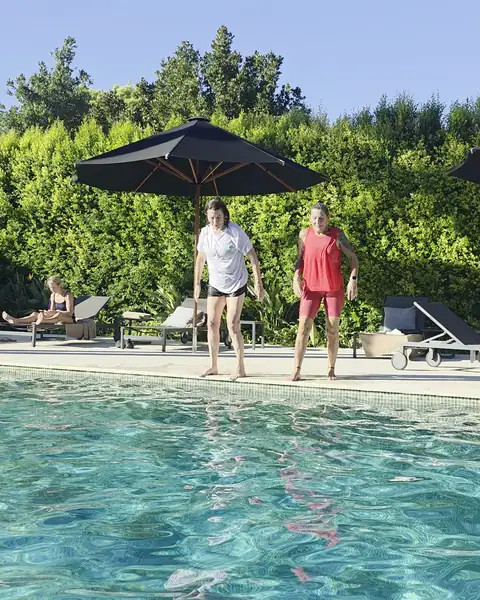 Guests jumping into the villa pool.